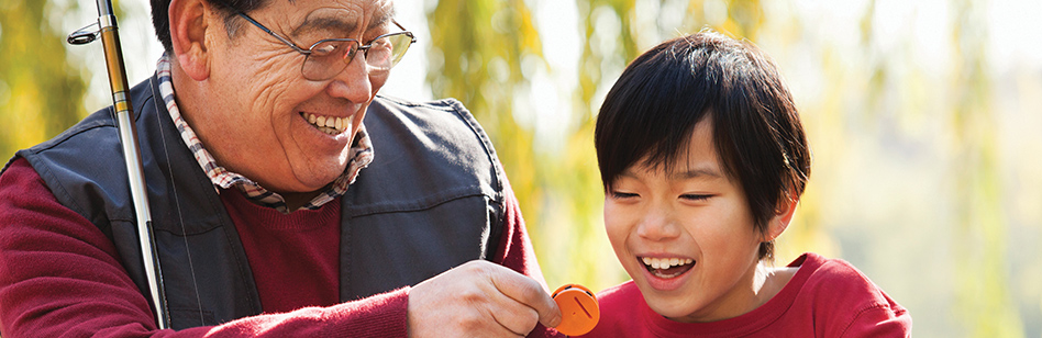 Asian father and son looking at fishing lure. Asian father and son looking at fishing lure.
