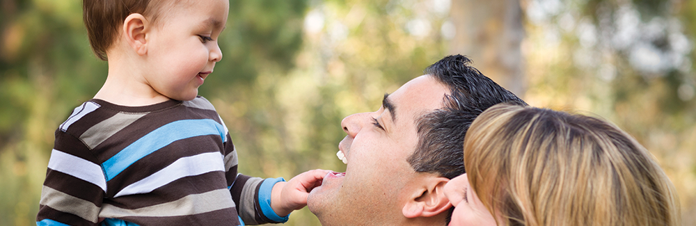 little boy looking in Dads mouth