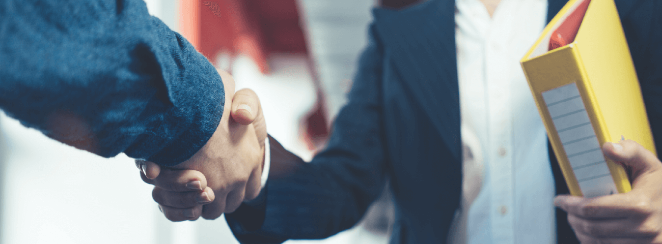 dental-select-hero Two businessmen shaking hands.