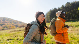Two individuals on a hike outdoors.