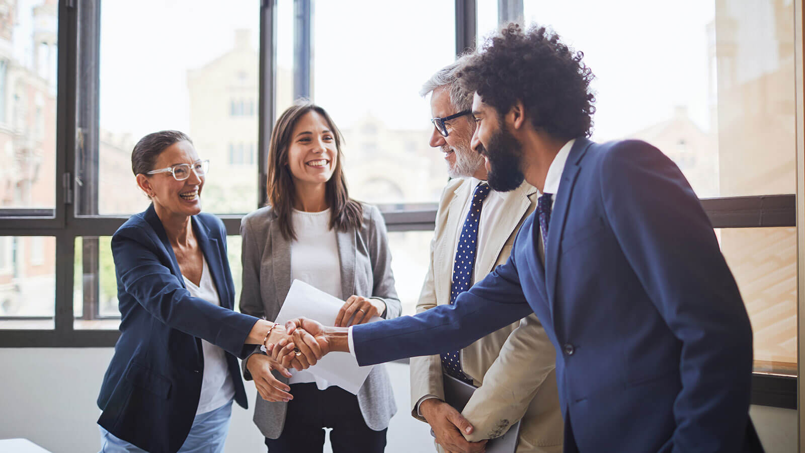 Small group of business professionals shaking hands. Small group of business professionals shaking hands.