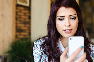 Beautiful young woman talking on the phone with video call
