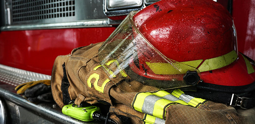 Firefighter's gear sitting on a firetruck.