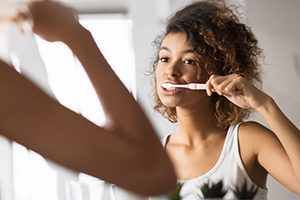 African American Girl Brushing Teeth With Toothbrush In Bathroom, Panorama