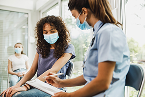 African American Girl Talking To Nurse Before Covid-19 Vaccine