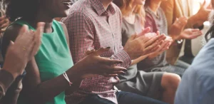 An audience clapping their hands.