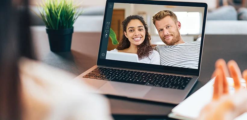 A couple shown on a laptop screen doing a webex with their financial advisor.