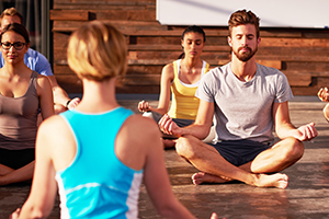 A yoga instructor holding class.