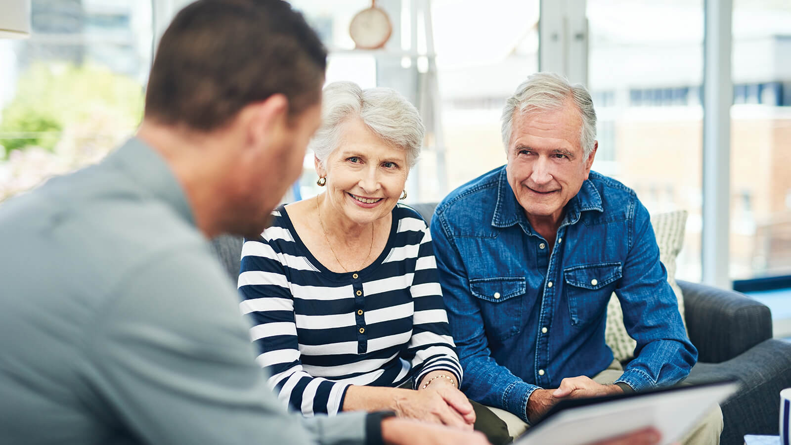 A couple in their 60s meet with a financial professional to talk about their annuity and how it will create retirement income.