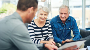 A couple in their 60s meet with a financial professional to talk about their annuity and how it will create retirement income.