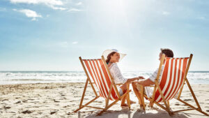 A husband and wife enjoy their retirement together on a beach because they planned well with an annuity indexing strategy.