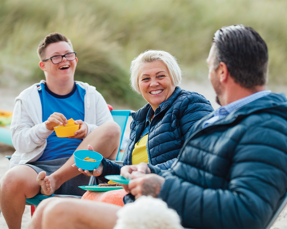 Family enjoying picnic on the beach