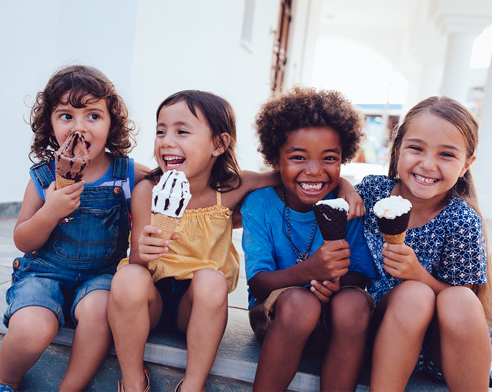 Multi-ethnic friends children eating ice cream