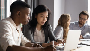 Four coworkers working together at a table.