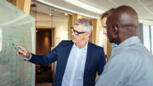 Colleagues plan at a whiteboard