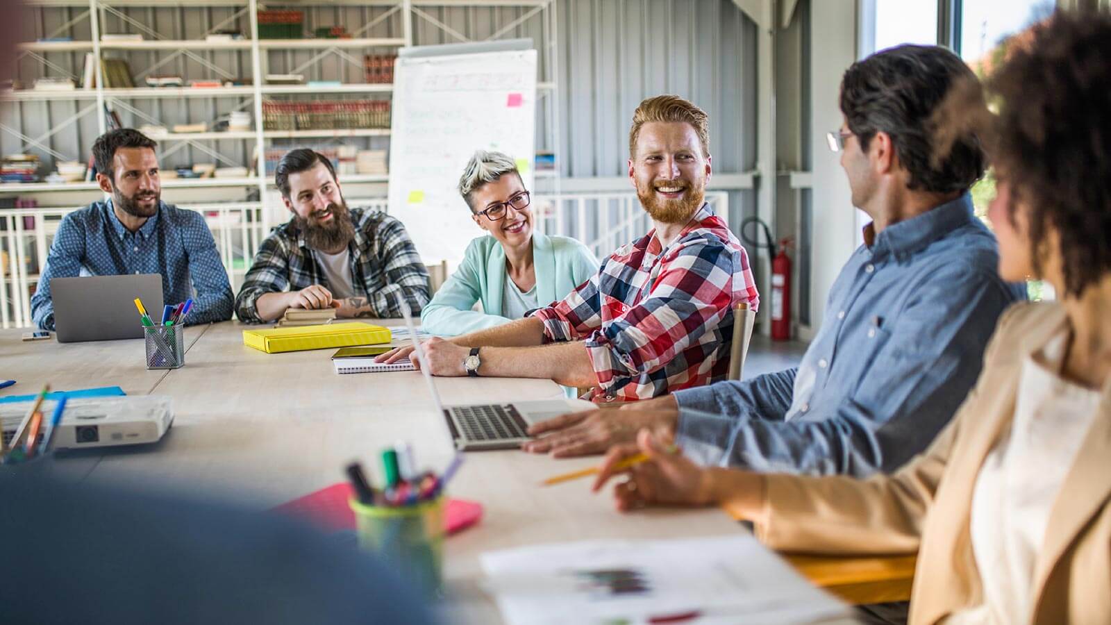 Colleagues sitting around a table having a meeting.