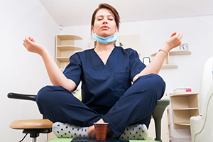 Female employee at dentist office meditating.