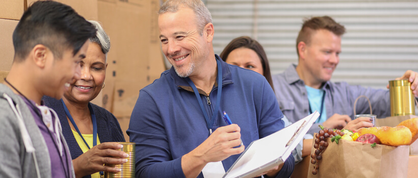 A nonprofit organization holds a volunteer event to pack boxes for underserved families.