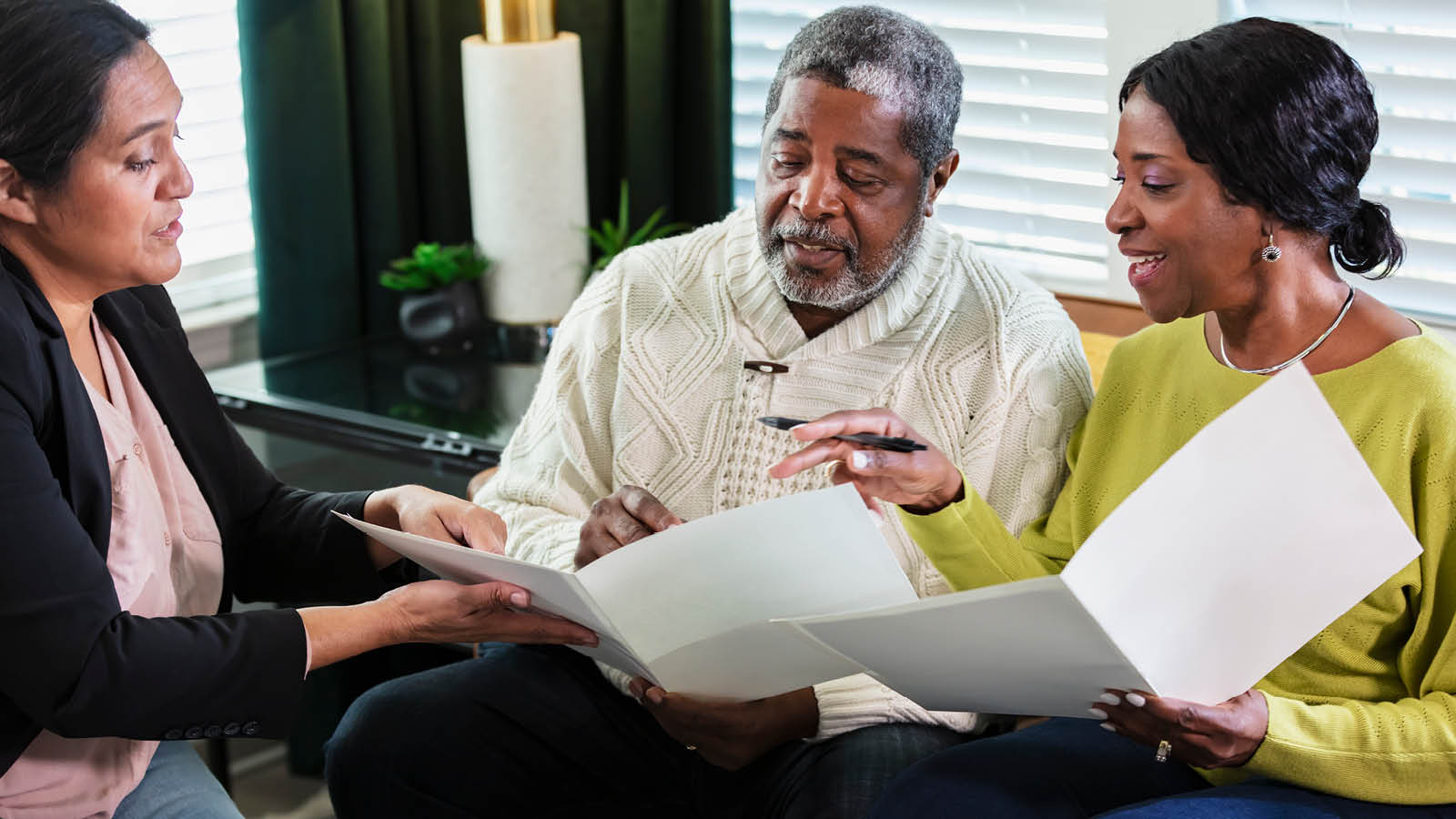 3812837 Estate Planning - FP Blog_1600x900 A financial professional meets with her clients to answer their nontax estate planning questions.