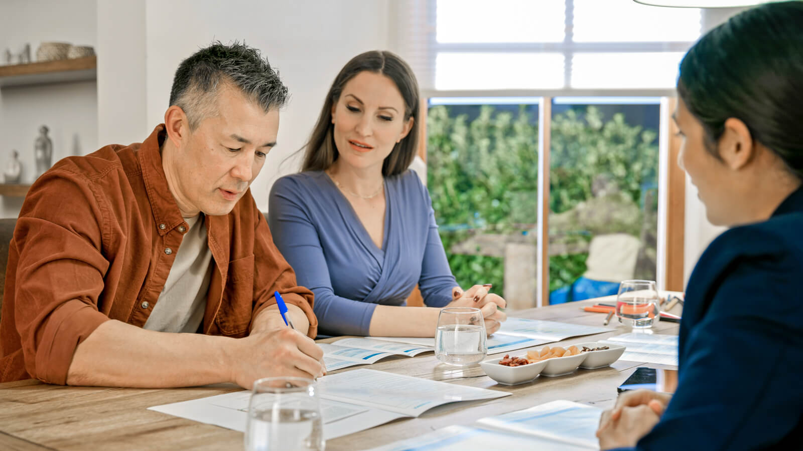 A couple meets with their financial professional to learn about while life insurance with dividends.