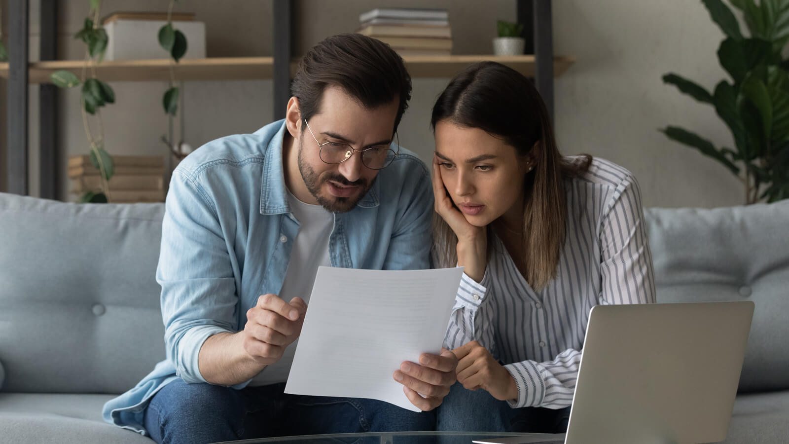 Young couple reading over a life insurance policy.