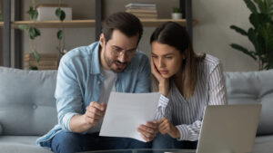 Young couple reading over a life insurance policy.