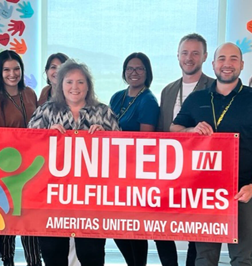 Ameritas associates holding United Way campaign banner.