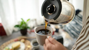 Pouring a cup of coffee.