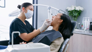 Dentist, woman and patient with tools for teeth work.