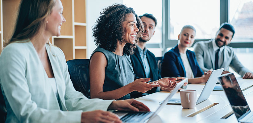 A group of people attending a meeting at an office conference room.