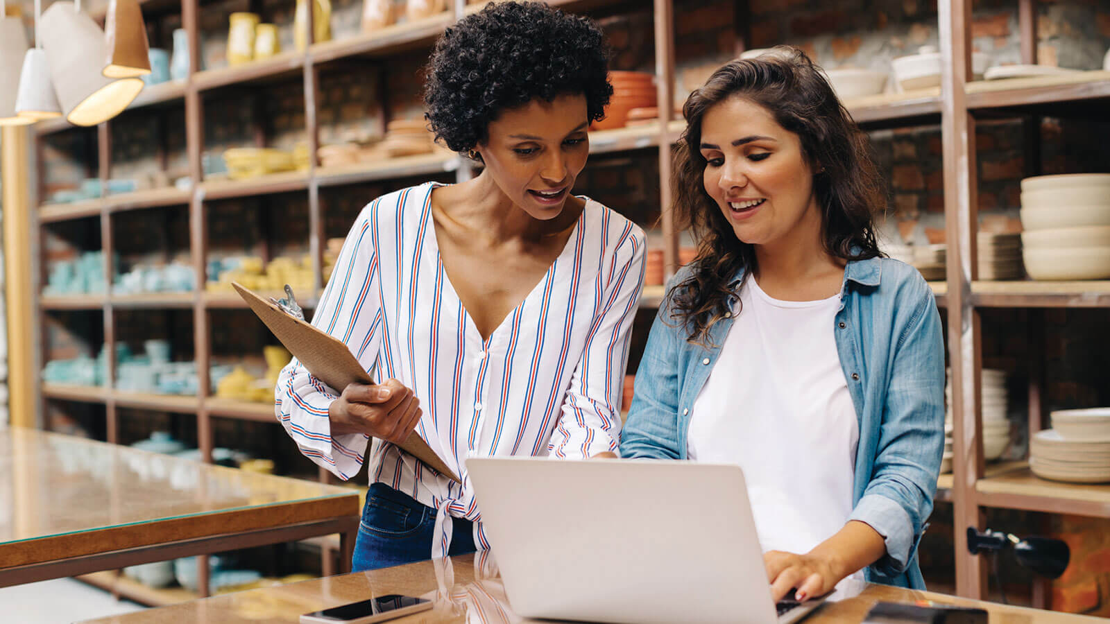 A business owner reviews an important order with her key employee.
