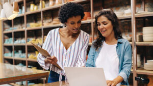 A business owner reviews an important order with her key employee.