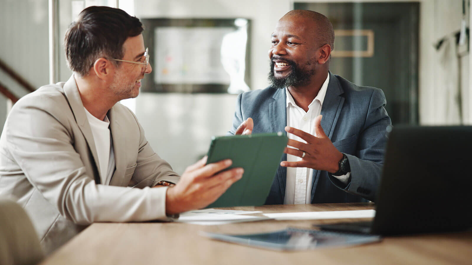 A financial professional meets with his client in an office to discuss liquidity management strategies.