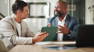 A financial professional meets with his client in an office to discuss liquidity management strategies.