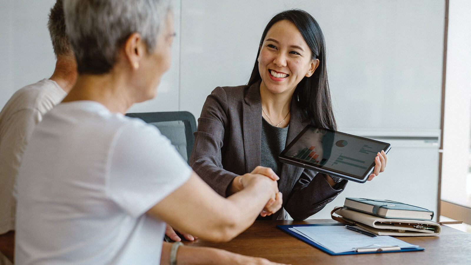A female financial professional meets with her client, reflecting career growth and leadership opportunities for women in financial services.
