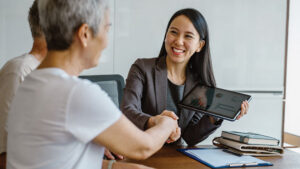 A female financial professional meets with her client, reflecting career growth and leadership opportunities for women in financial services.