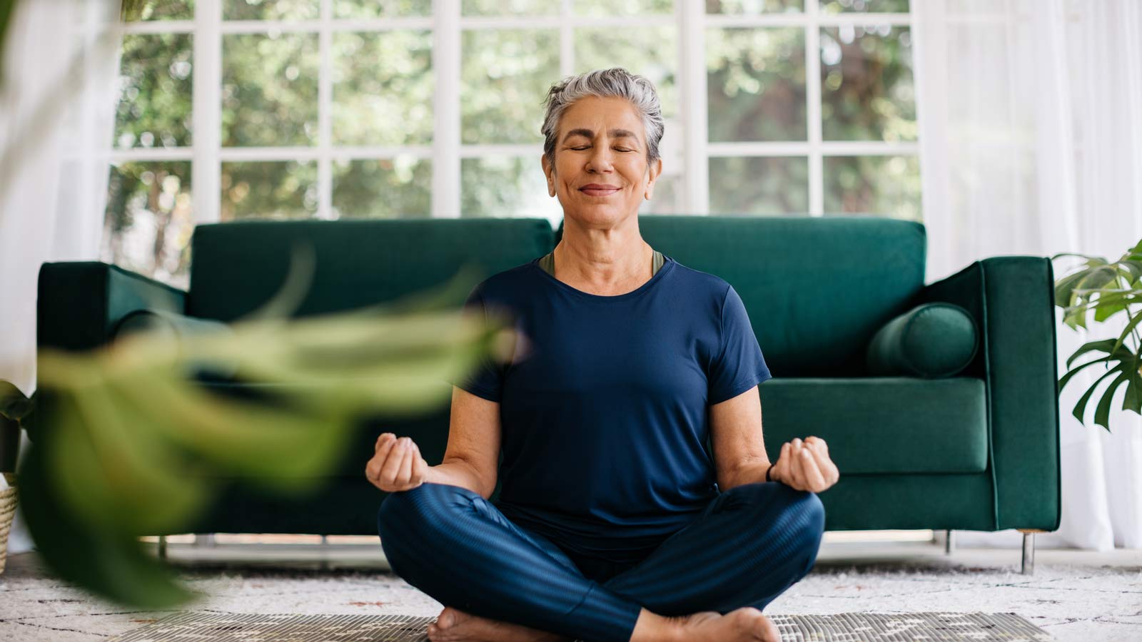 Woman closing eyes while smiling and meditating.