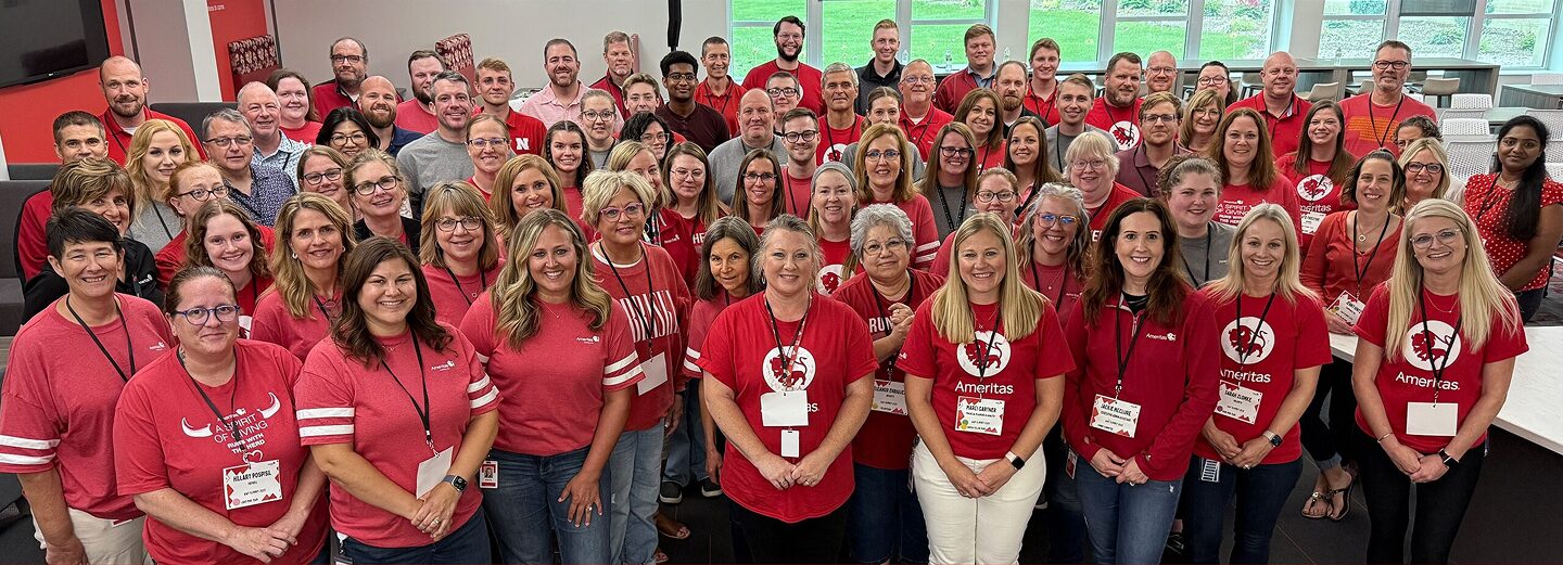 A group of Ameritas associates gathering for a photo in the Home Office.