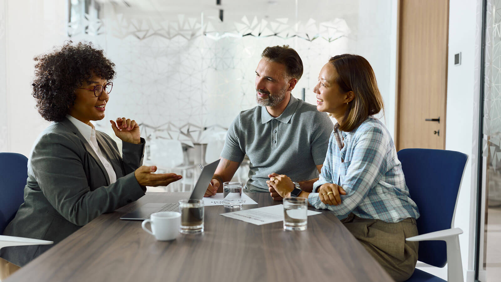 A financial professional meets with her clients in her office to discuss if term life insurance may be a good fit for their financial strategy and goals.