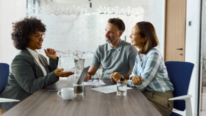 A financial professional meets with her clients in her office to discuss if term life insurance may be a good fit for their financial strategy and goals.