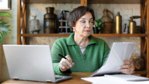 A woman in her 60s reviews financial options of where to keep her money safe for a short period while still growing.