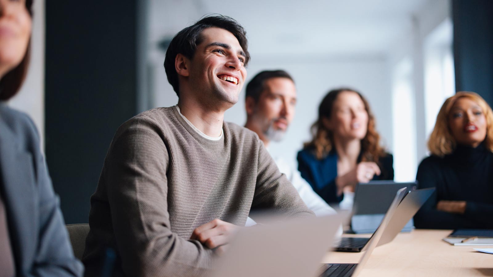 Group of three employees discussing their benefits.